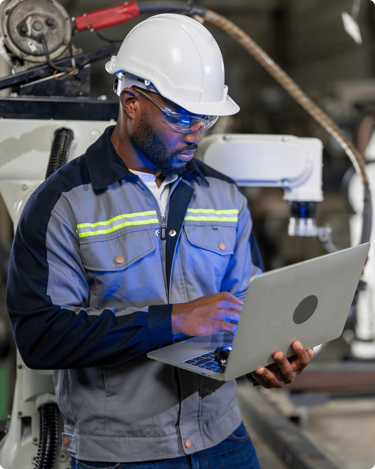 Engineer working on laptop in factory